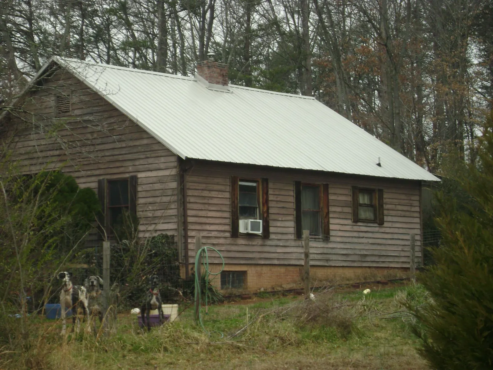 White metal roof on an old wood sided farmhouse, from a Asphalt Shingle Roof Repair job in Genesee Depot